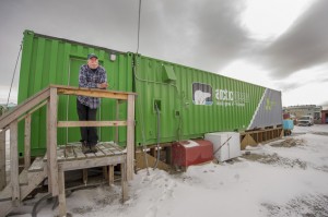 An employee waits outside an indoor vertical farm in Kotzebue, Alaska. The unit provides kale, various lettuces, basil and other greens for the community of nearly 3,300. Source: Will Anderson via AP