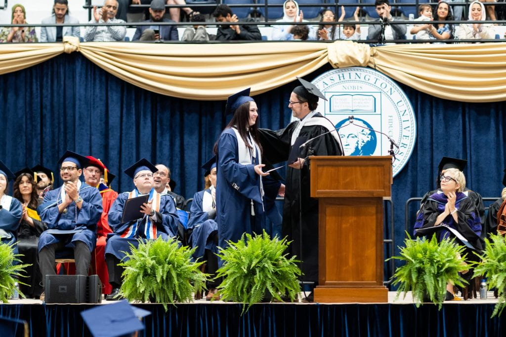 Isabella Greene receives the CPS Graduate Distinguished Scholar Award at the 2023 CPS Commencement Ceremony.