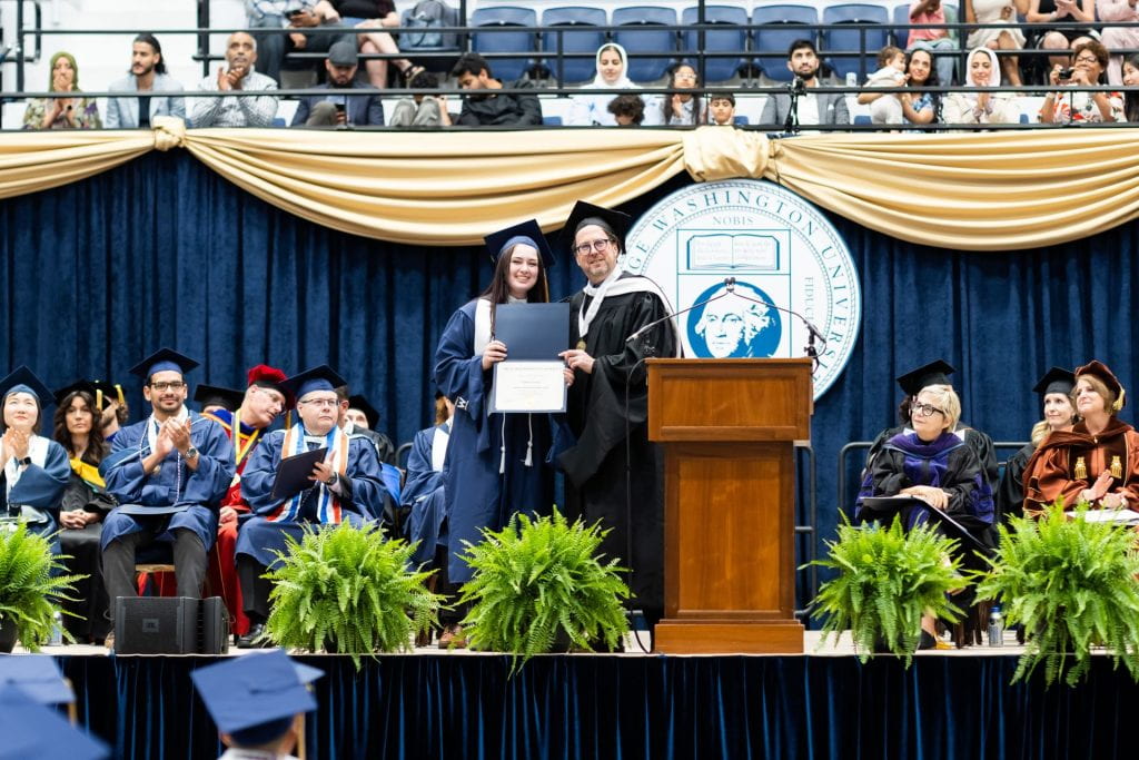 Isabella Greene receives the CPS Graduate Distinguished Scholar Award at the 2023 CPS Commencement Ceremony.
