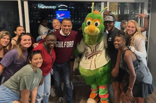 Kyle Farmbry with Guilford students at a Greensboro Grasshoppers game.