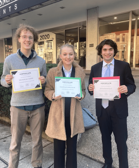 Three students holding awards from G20 Summit