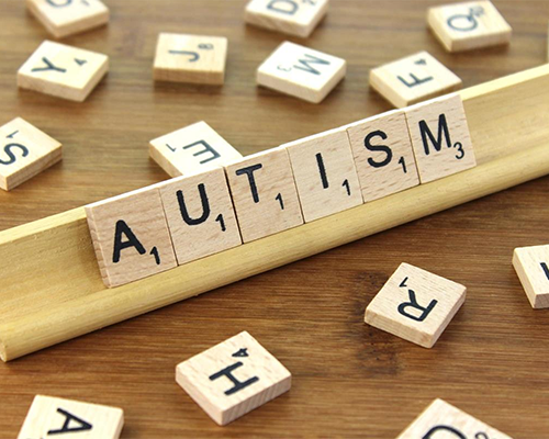 Scrabble image, with pieces spelling "autism"