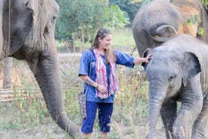 Nadia Mathis petting elephants in Thailand