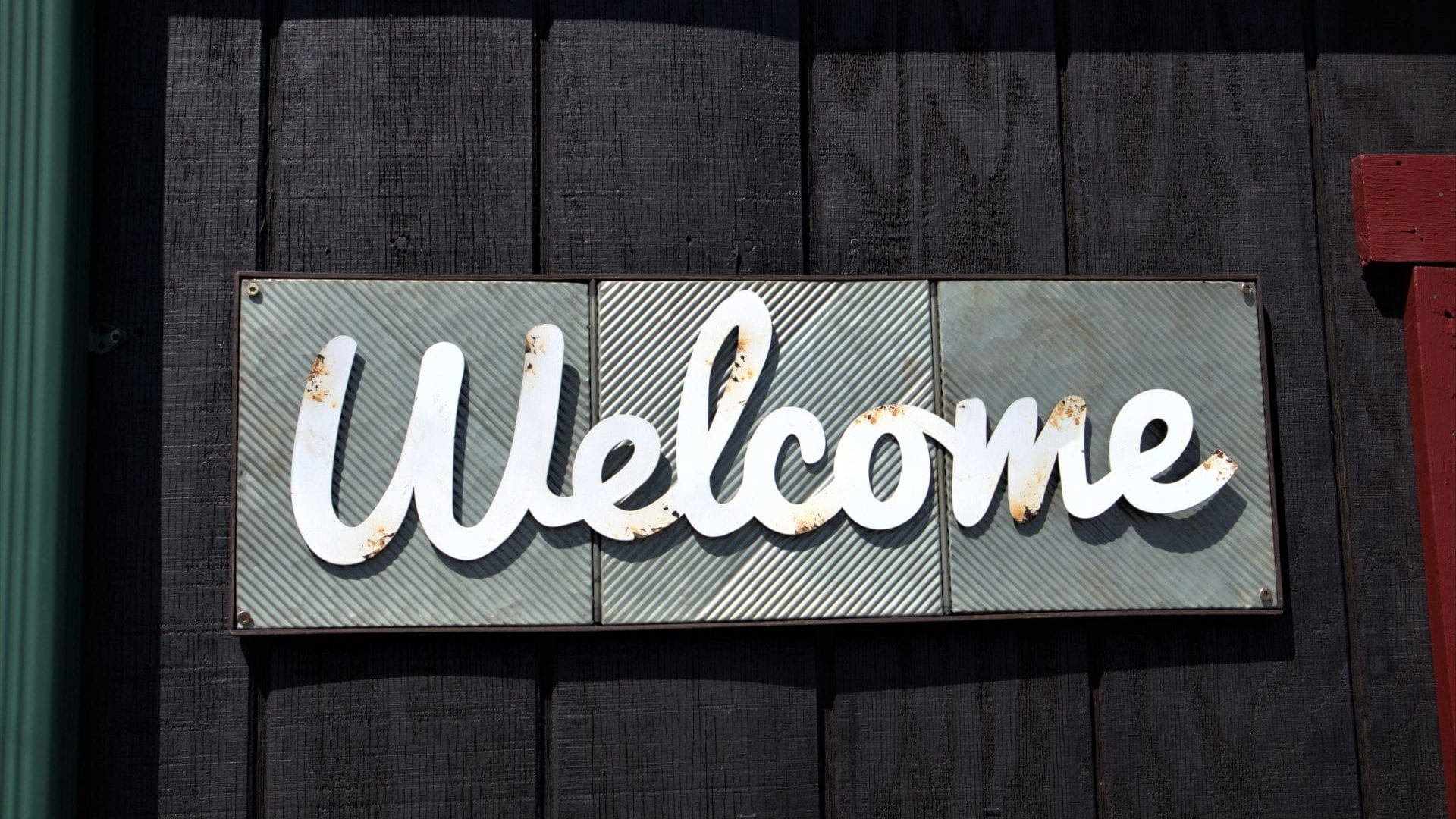 Welcome sign on wooden background.