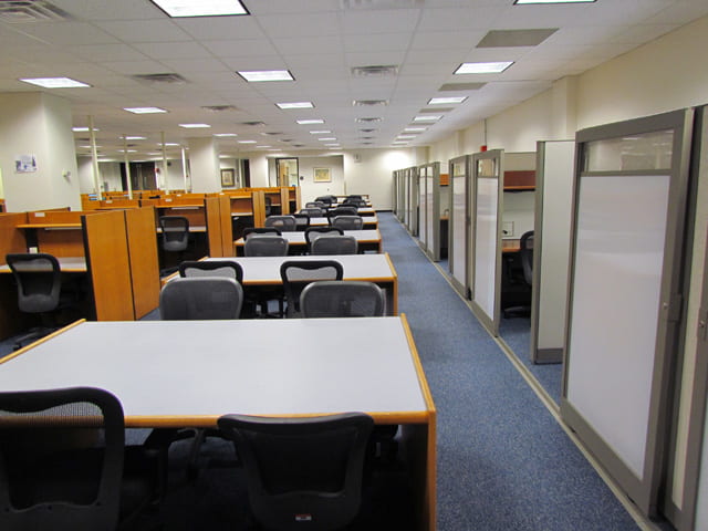 Image of communal tables and study spaces in Himmelfarb library. 