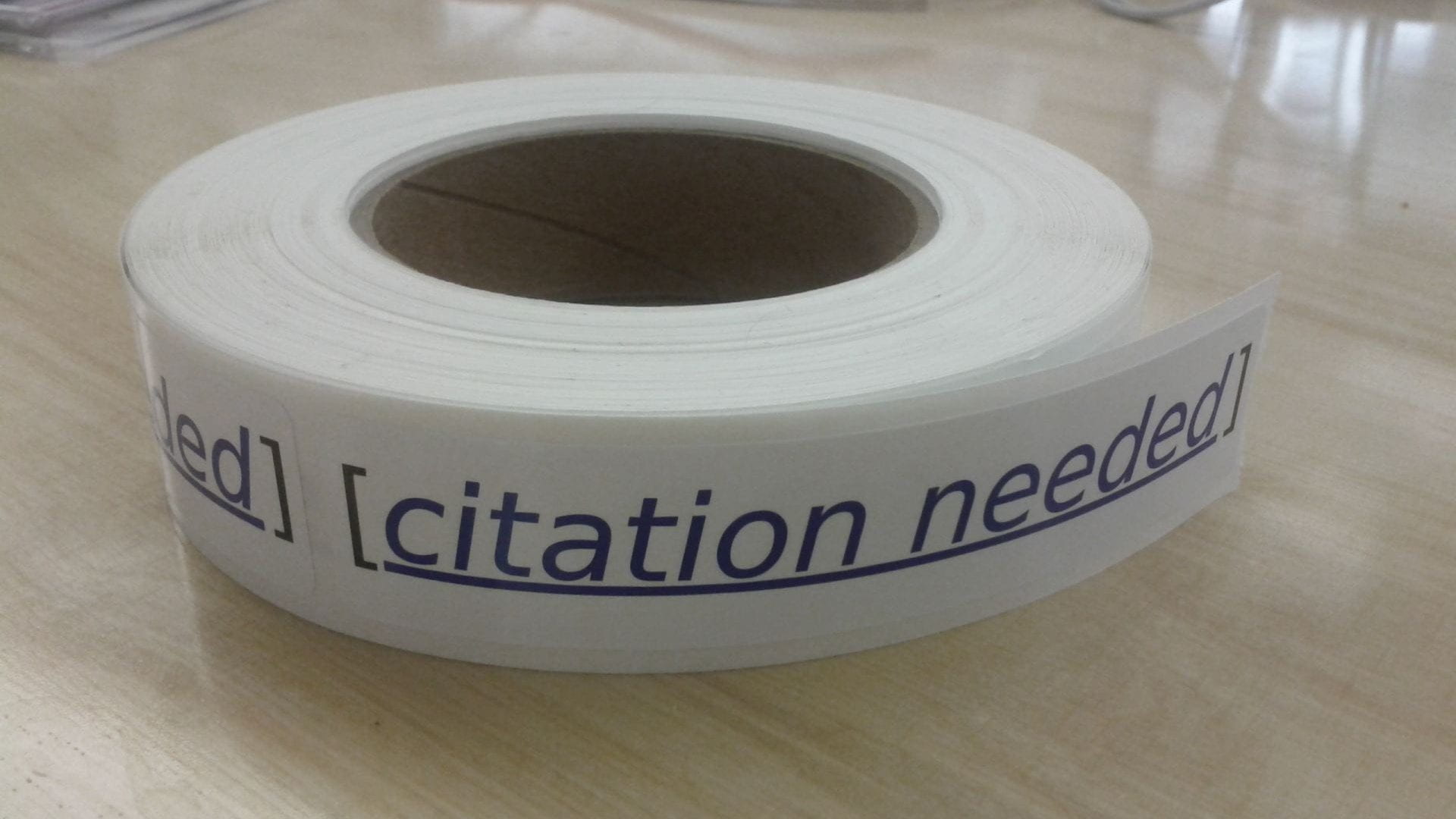 Picture of a roll of stickers that say "Citation Needed"