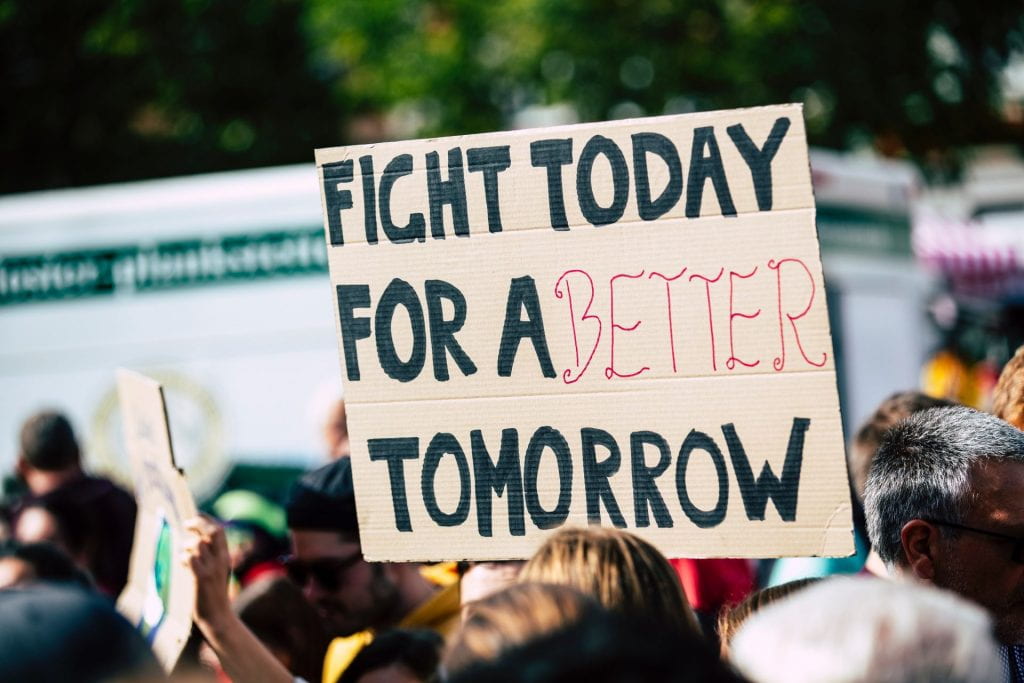 Photo of sign that reads 'Fight Today for a Better Tomorrow' at a demonstration
