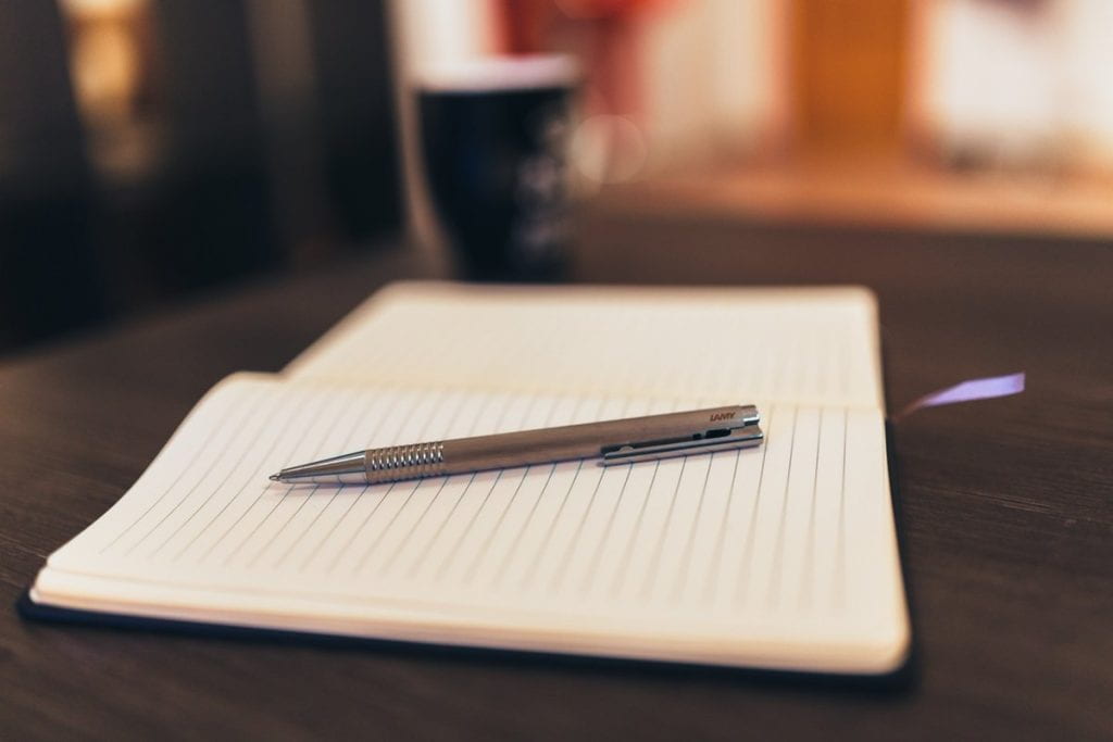 Image of open notebook with pen