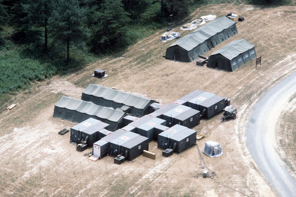 Aerial photograph of set of military hospital tents in an open field.