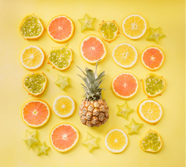 Decorative image of citrus fruits sliced and placed on a yellow background.