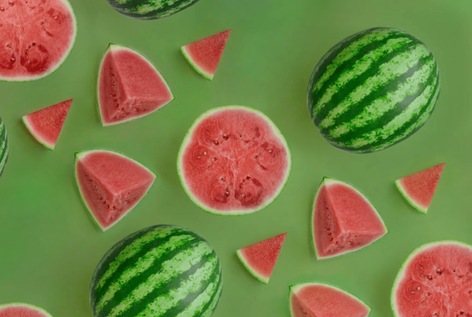 Image of watermelons (whole and sliced) on a green background.