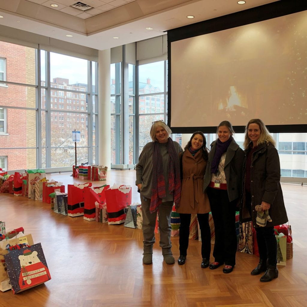 Catherine and current Himmelfarb Librarians Sara Hoover, Ruth Bueter, and Laura Abate at the GW Give a Gift present drop-off.