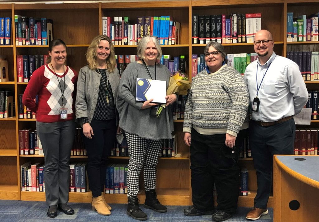 Catherine with Himmelfarb staff after receiving the SMHS Dean’s Excellence in Service Award in March 2022.