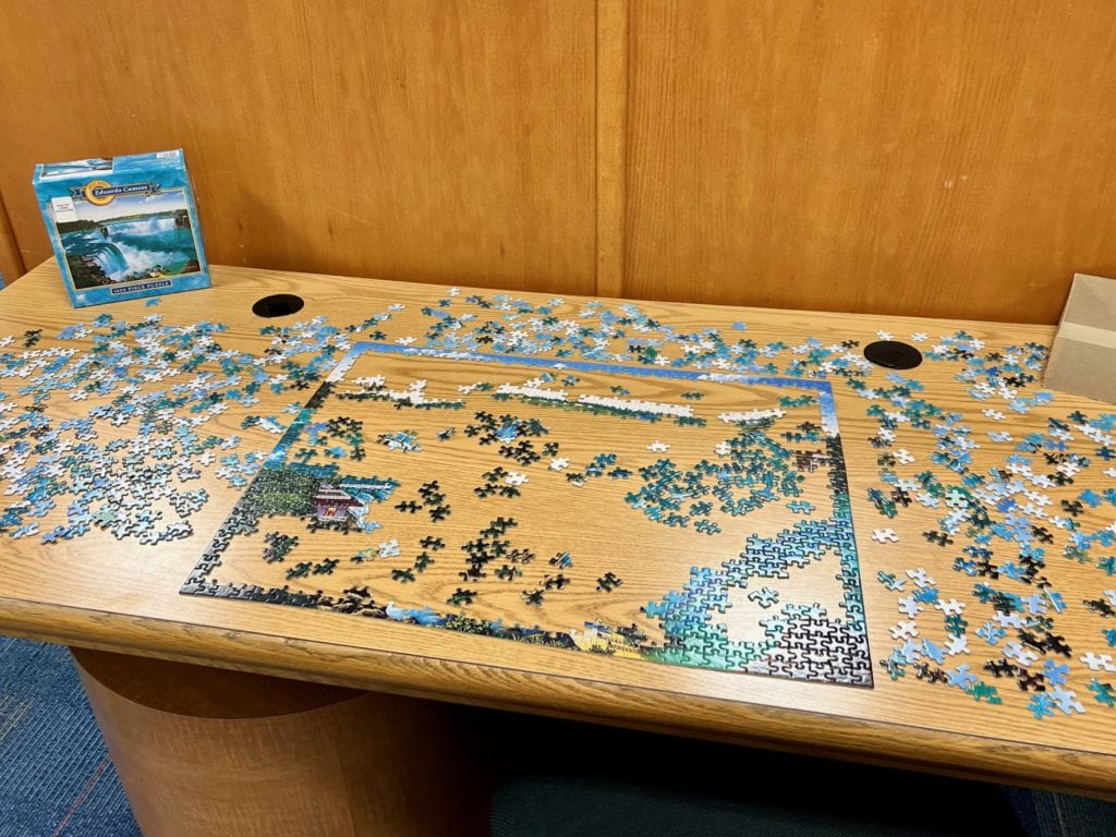 Picture of a jigsaw puzzle on a wooden table.