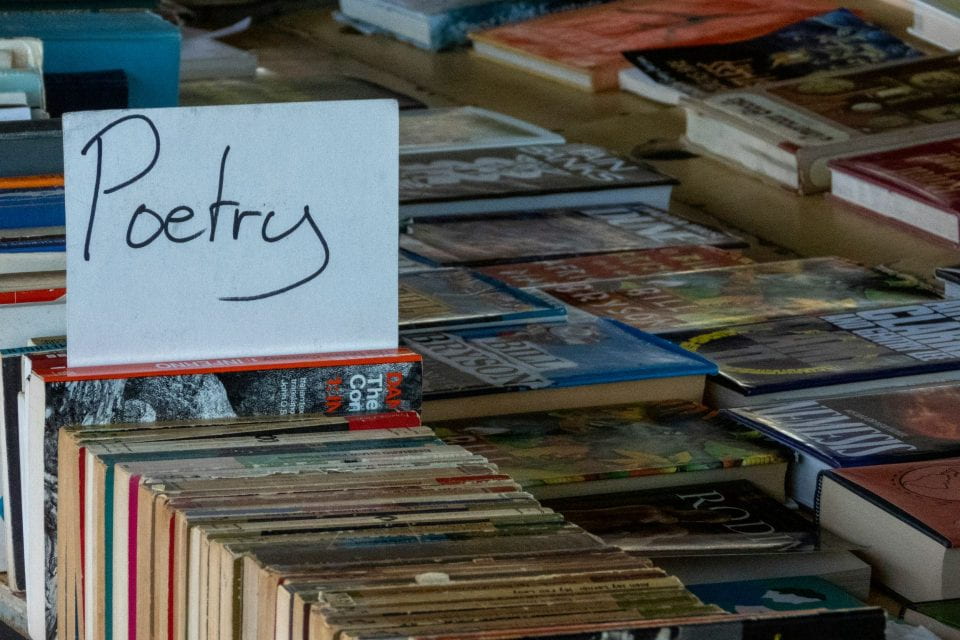 Book sale table, displaying poetry section