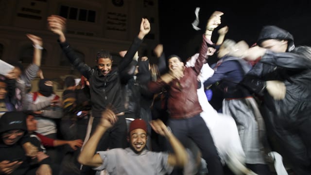 Activists against Egyptian President Mursi perform the "Harlem Shake" in front of the Muslim Brotherhood's headquarters in Cairo