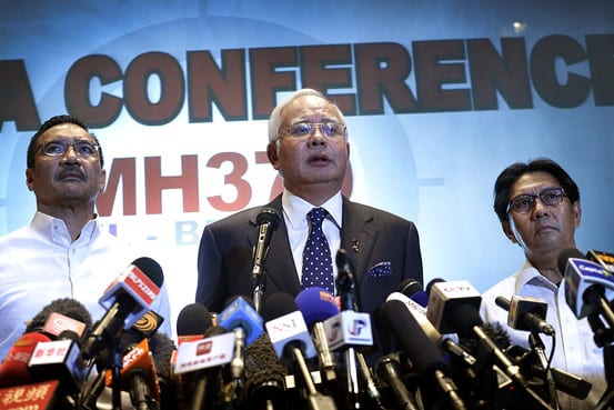 Malaysian Prime Minister Najib Razak, center, Malaysia’s Minister for Transport Hishamuddin Hussein, left, and director general of the Malaysian Department of Civil Aviation, Azharuddin Abdul Rahman, deliver a statement on the missing Malaysia Airlines jetliner on Mar. 15, 2014. Credit: Associated Press via WSJ.com