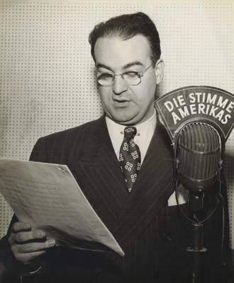 Walter Roberts speaking from behind a microphone in the early days of the Voice of America. Credit: U.S. government