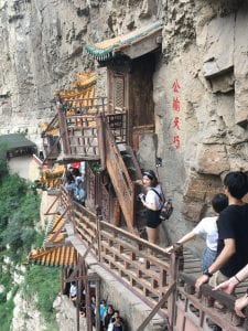 walkway and tourist area attached to the side of a mountainous rock 